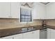 Granite counters and stainless steel appliances complement the white cabinets in this kitchen at 3841 Admiral Dr, Atlanta, GA 30341