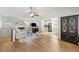Open-concept living room with hardwood floors, a fireplace, and seamless flow to the kitchen at 3841 Admiral Dr, Atlanta, GA 30341