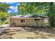 View of backyard with a brick paver patio in a yard surrounded by a dense tree line, and a brick exterior at 793 Springdale Sw, Atlanta, GA 30315
