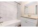 A bright bathroom features marble tile detail in the shower and tub area, and neutral granite on the vanity at 793 Springdale Sw, Atlanta, GA 30315