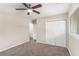Bright bedroom featuring neutral walls, a carpeted floor, a ceiling fan and a double door closet at 793 Springdale Sw, Atlanta, GA 30315