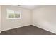 The bedroom offers neutral paint, carpet, and a window with views of outside at 793 Springdale Sw, Atlanta, GA 30315