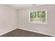 Bedroom featuring neutral walls, carpeted floor, and a window view of the green trees outside at 793 Springdale Sw, Atlanta, GA 30315