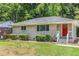 Charming one-story home with a brick exterior, well-maintained lawn, and a pop of color from the red front door at 793 Springdale Sw, Atlanta, GA 30315