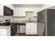 Modern kitchen featuring stainless steel appliances, granite countertops, and sleek white cabinetry at 793 Springdale Sw, Atlanta, GA 30315