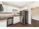 A well-lit kitchen features stainless steel appliances, white cabinets, and granite countertops at 793 Springdale Sw, Atlanta, GA 30315