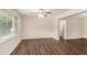Spacious living room with hardwood floors, neutral walls, a ceiling fan and a large window at 793 Springdale Sw, Atlanta, GA 30315