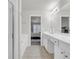Clean and modern bathroom featuring dual sinks, tile floors, and a shower with glass door at 1804 Evadale Ct # 1, Mableton, GA 30126