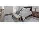 Well-lit bedroom boasts wood floors, large bed, and bench, creating a relaxing retreat at 1804 Evadale Ct # 1, Mableton, GA 30126