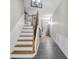 Welcoming entryway with hardwood flooring, a staircase, and decorative lighting fixture at 1804 Evadale Ct # 1, Mableton, GA 30126