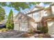 Charming townhome exterior features a two-car garage, stone accents, and well-kept landscaping at 1804 Evadale Ct # 1, Mableton, GA 30126