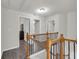 Upstairs hallway with wood banister, decorative iron spindles, and wood-look floors at 1804 Evadale Ct # 1, Mableton, GA 30126