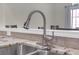 Close up of stainless steel kitchen faucet and countertop with granite tile backsplash and sink with double basin at 1804 Evadale Ct # 1, Mableton, GA 30126