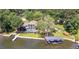 Stunning waterfront property featuring a private boat dock, sparkling pool, and lush green landscaping at 2775 Club Valley Ct, Jonesboro, GA 30236