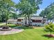 Stately home featuring a circular driveway, lush lawn, and access to a tranquil lake at 2775 Club Valley Ct, Jonesboro, GA 30236