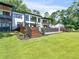 Lush backyard view showcasing the home's expansive outdoor living spaces and beautiful landscaping at 2775 Club Valley Ct, Jonesboro, GA 30236