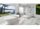 This bathroom features a soaking tub with a view of the lake and a glass walk-in shower at 2775 Club Valley Ct, Jonesboro, GA 30236