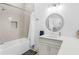 Bright bathroom features a tub, shower, white cabinets, and a decorative mirror at 2775 Club Valley Ct, Jonesboro, GA 30236