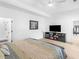 This bedroom boasts a media center and ensuite bathroom with sleek, modern finishes at 2775 Club Valley Ct, Jonesboro, GA 30236