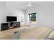 Modern bedroom features a ceiling fan, light wood floors, and a media center at 2775 Club Valley Ct, Jonesboro, GA 30236