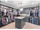 This walk-in closet features custom storage and a chandelier at 2775 Club Valley Ct, Jonesboro, GA 30236