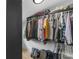 Organized walk-in closet with hanging clothes and overhead storage at 2775 Club Valley Ct, Jonesboro, GA 30236