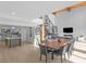 Open-concept with dining area, kitchen, and access to modern staircase at 2775 Club Valley Ct, Jonesboro, GA 30236