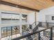 Light-filled entryway with modern railings, lake views through expansive windows, and wood accents at 2775 Club Valley Ct, Jonesboro, GA 30236