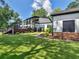 Sprawling green lawn leading to a modern home with outdoor patios at 2775 Club Valley Ct, Jonesboro, GA 30236