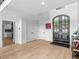 Bright foyer with hardwood floors, decorative front doors and access to kitchen at 2775 Club Valley Ct, Jonesboro, GA 30236