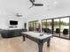 Spacious game room with a pool table, lake view, and comfortable seating area at 2775 Club Valley Ct, Jonesboro, GA 30236