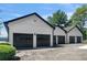 Detached four-car garage with dark doors and white siding at 2775 Club Valley Ct, Jonesboro, GA 30236