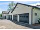 Detached four-car garage with dark doors and white siding at 2775 Club Valley Ct, Jonesboro, GA 30236