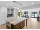 Open concept kitchen with center island and view of backyard dining and lake access at 2775 Club Valley Ct, Jonesboro, GA 30236