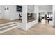 Open-concept living area with light wood floors and modern staircase at 2775 Club Valley Ct, Jonesboro, GA 30236