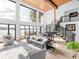 Modern living room featuring floor-to-ceiling windows with lake views, wood ceiling and open staircase at 2775 Club Valley Ct, Jonesboro, GA 30236