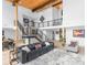 Spacious living room with modern staircase, wood beams and access to dining at 2775 Club Valley Ct, Jonesboro, GA 30236