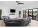 Living room boasts a large leather sofa, fireplace, and access to the outdoor patio at 2775 Club Valley Ct, Jonesboro, GA 30236