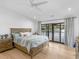 Serene main bedroom boasts hardwood floors, ceiling fan, and access to a lakeside patio at 2775 Club Valley Ct, Jonesboro, GA 30236