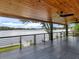 Spacious covered patio featuring a scenic water view and a wooden paneled ceiling with ceiling fan at 2775 Club Valley Ct, Jonesboro, GA 30236