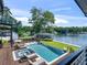 Aerial view of a luxurious backyard with pool, spa, lounge chairs and a water view at 2775 Club Valley Ct, Jonesboro, GA 30236