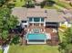 Aerial view of modern home boasting a luxurious pool, hot tub, spacious deck, and outdoor lounge area at 2775 Club Valley Ct, Jonesboro, GA 30236