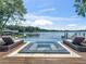 Relaxing pool and spa area with lounge chairs providing stunning views of the tranquil lake, creating a peaceful retreat at 2775 Club Valley Ct, Jonesboro, GA 30236