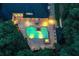Aerial view of illuminated pool, patio, and lush greenery surrounding the property, creating a private oasis at 2885 Coles Way, Atlanta, GA 30350