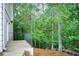 Backyard showing a patio with black metal fencing surrounded by green trees at 2885 Coles Way, Atlanta, GA 30350