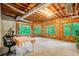 Unfinished basement with exposed wood beams, large windows, and ample natural light at 2885 Coles Way, Atlanta, GA 30350