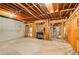 Unfinished basement features exposed beams, concrete walls, and visible utilities, offering potential for customization at 2885 Coles Way, Atlanta, GA 30350