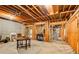 Unfinished basement featuring exposed ductwork, wood beams, and a modern fireplace at 2885 Coles Way, Atlanta, GA 30350