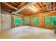 Unfinished basement features a concrete floor and multiple windows with woodland views, allowing natural light at 2885 Coles Way, Atlanta, GA 30350
