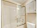 Bathroom featuring a bathtub with gold trim, sliding glass doors, and a white toilet at 2885 Coles Way, Atlanta, GA 30350